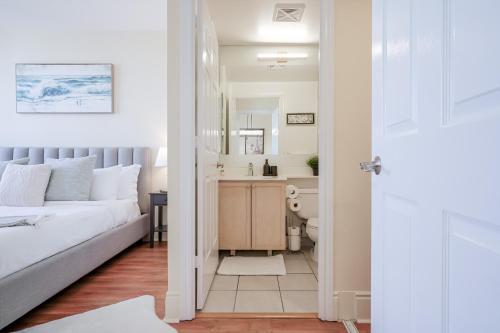 Un dormitorio con una cama y un baño con lavabo. en Luxury 2BR 2BA Penthouse by Celebration Sq YYZ UFT, en Mississauga