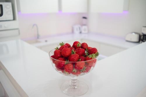a bowl of strawberries on a counter in a kitchen at Sofia Apartment in Budapest