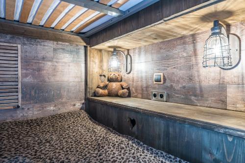 a teddy bear sitting on a counter in a room at Chalet Refuge Loup Blanc Valfréjus in Valfréjus