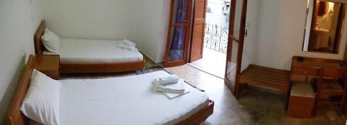 a room with two beds and a mirror in it at Samaria in Agia Roumeli
