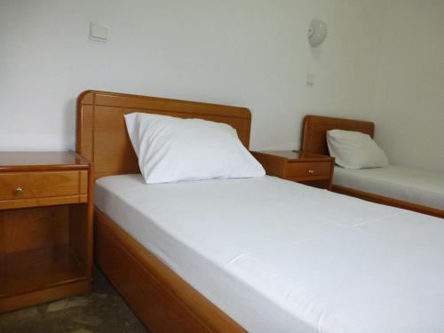 a bedroom with two beds and two night stands at Samaria in Agia Roumeli