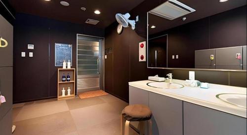 a large bathroom with a sink and a shower at Super Hotel Arai-Niigata in Myoko