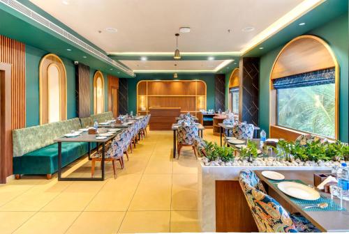 a dining room with long tables and chairs at PASSIONS HOTEL EDATHUA - Alappuzha in Champakulam