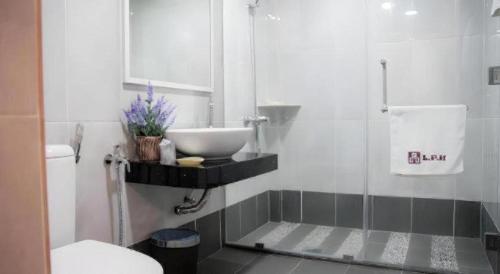 a bathroom with a sink and a shower at Lipis Plaza Hotel in Kuala Lipis