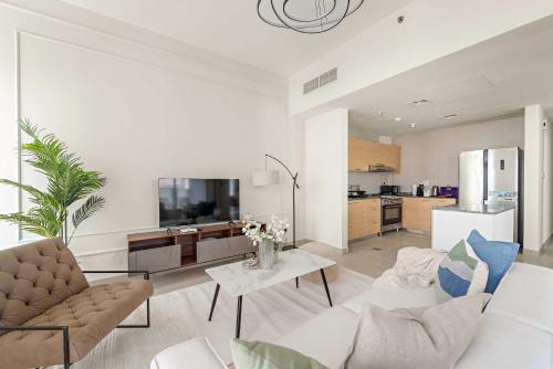 a living room with a couch and a table at Silkhaus Luxury 2BR Stay in Reem Island Sigma II in Abu Dhabi