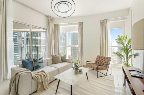 a living room with a couch and a table at Silkhaus Luxury 2BR Stay in Reem Island Sigma II in Abu Dhabi