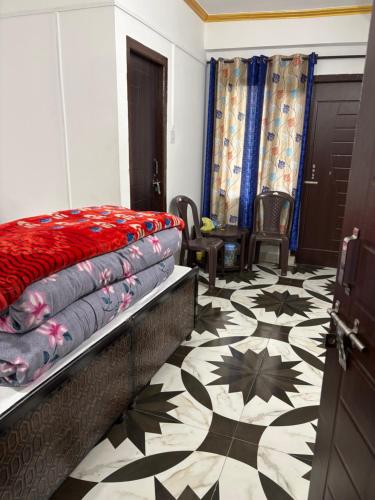 a bedroom with a bed and a patterned floor at Krishna home stay in Tārna