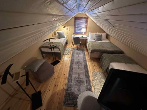 a room with two beds and a tv in a tent at Daltorps skola in Skövde