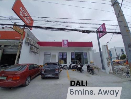 a gas station with cars parked in front of it at NAIA Airport Vanløse Studio by Velkommen Guest PH in Manila