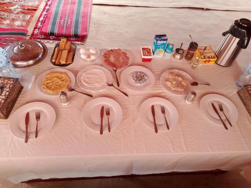 a table with plates of food on top of it at Wadi Rum Camp &Tours in Wadi Rum