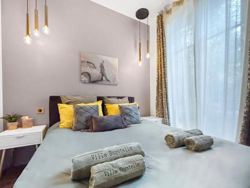a bedroom with a large bed with pillows on it at Grand T4 Luxe, SPA, Cheminée Baby-foot, Jardin in Aix-les-Bains