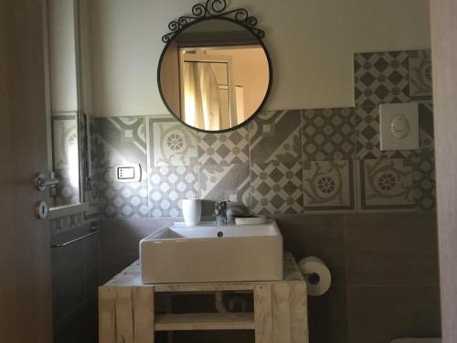 a bathroom with a sink and a mirror at B&B La Via di Casa in San Leone