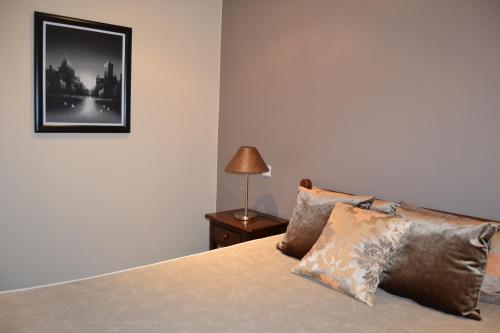 a bedroom with a bed with a lamp and a picture at Quinta do Mosteiro in Felgueiras