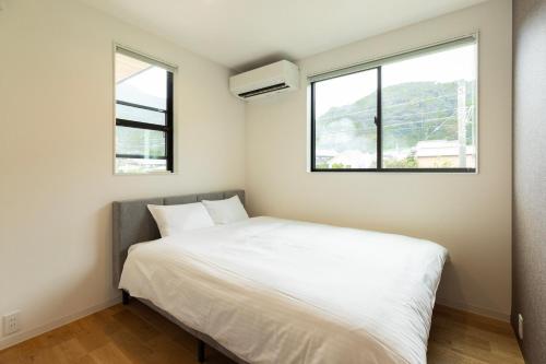 Voodi või voodid majutusasutuse 海沿いの1日1組限定の貸切別荘 Smile Itoshima Stay toas