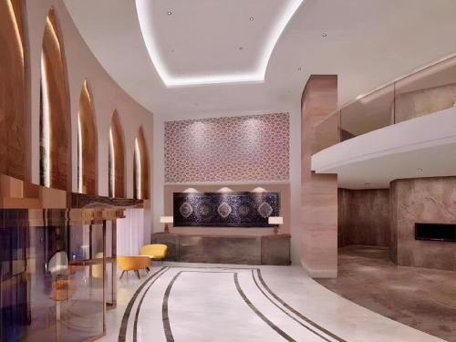 a lobby with a hallway with a table and chairs at Jinjiang Inn Select Urumqi Midong Avenue in Ürümqi