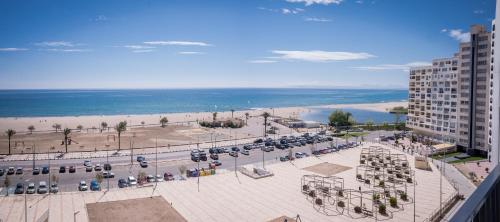 a parking lot with a beach and a building at Ampuries Delta Apartment in Empuriabrava