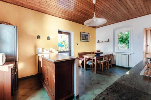 a kitchen and dining room with a table and a refrigerator at Varenna Wonders by Quokka 360 - Lakeside villa with breathtaking view in Fiumelatte