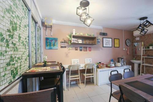 a kitchen with a table and a counter with chairs at D'Noor Budget Inn in Kota Bharu