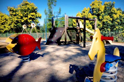 a playground with a monkey at Apartamentos do Lago in Ferreira do Zêzere