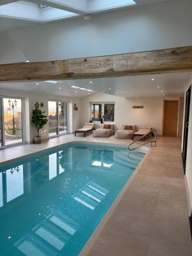a swimming pool in a house with a living room at Stunning Beach House Indoor Pool in Portsmouth