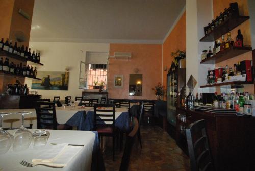a restaurant with tables and chairs and a bar at Albergo La Vela in Rapallo