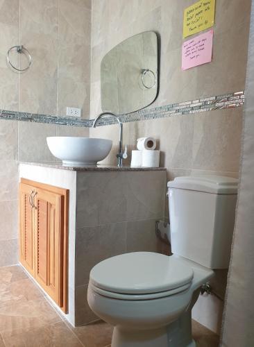 a bathroom with a toilet and a sink at Penzy Guest House in Chaweng