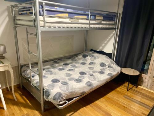 a bunk bed in a small room with a bunk bedutenewayangering at Studio tout confort bien situé in Orléans