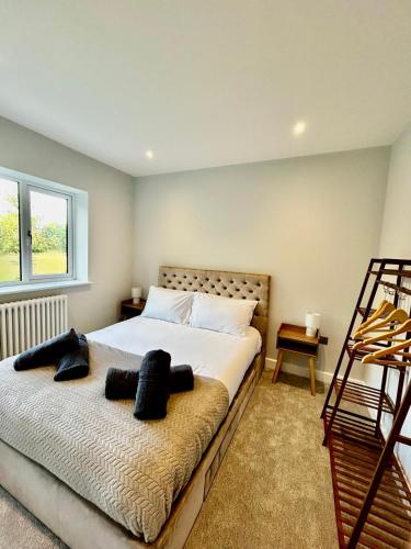 a bedroom with a bed with two pillows on it at Marzion House with Hot Tub in Tattershall Thorpe