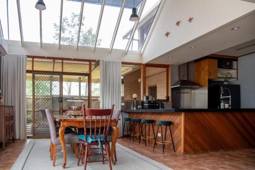 an open kitchen with a wooden table and chairs at Willow Lodge Retreat in Paringa