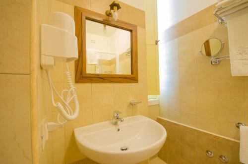 a bathroom with a white sink and a mirror at Il Casino di Remartello in Loreto Aprutino