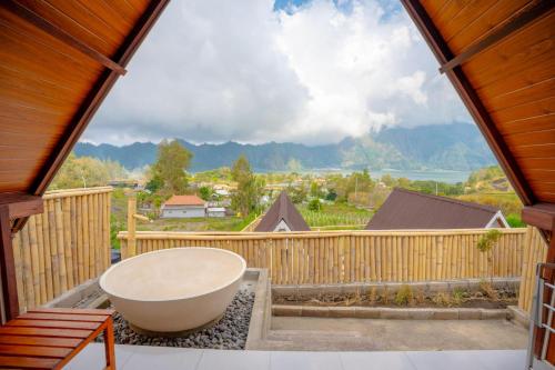 a large bathroom with a tub on a balcony at Tirta Rahayu Camp in Kubupenlokan