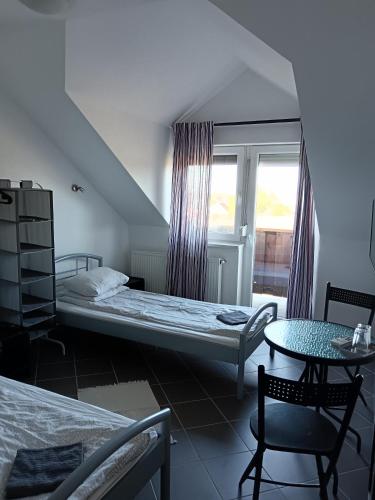 a bedroom with a bed and a table and a window at Kisdunapart 510 in Taksony