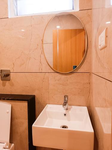 a bathroom with a sink and a mirror at tan90 Comfort Stays in Tiruchirappalli