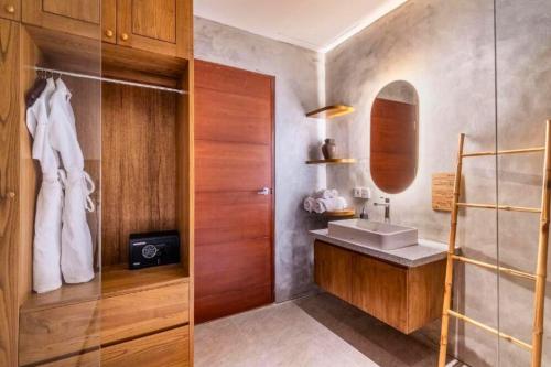 a bathroom with a sink and a mirror at Esmeralda1 BR Shared Pool ZN284 in Pererenan