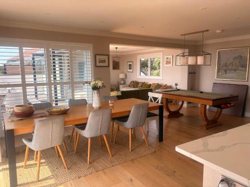 a living room with a table and a pool table at Stunning Beach House Indoor Pool in Portsmouth