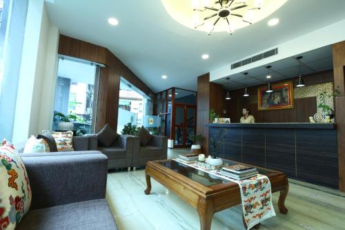 a living room with a couch and a coffee table at DEWALING by Laughing Lama Hotels in Phuntsholing