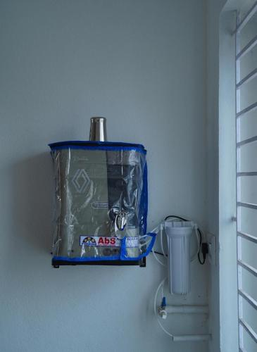 a blue container sitting on a wall next to a toilet at Kavitha Stay Inn in Nāmakkal