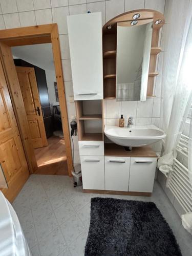a bathroom with a sink and a mirror at Panoramahütte Hochrindl in Hochrindl