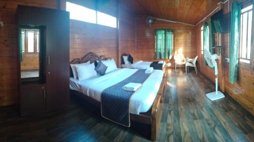 a bedroom with a large bed in a wooden room at Garden Woods in Yercaud
