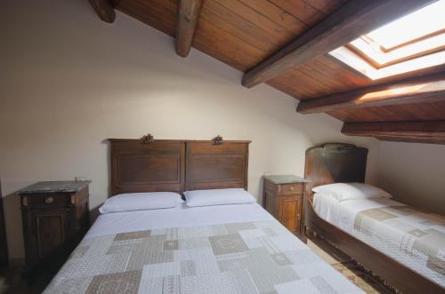 a bedroom with two beds with wooden furniture and a window at Il Casino di Remartello in Loreto Aprutino