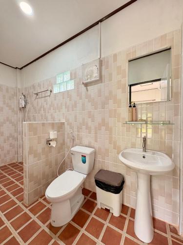 a bathroom with a toilet and a sink at Khao Sok Backpacker Hostel in Khao Sok National Park