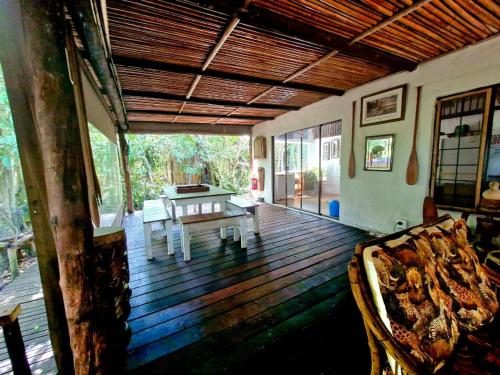 a living room with a table and a couch on a wooden deck at Shengeza Lake Lodge in KuShengesa