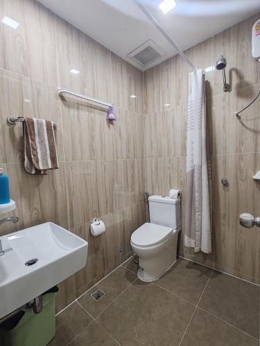 a bathroom with a toilet and a sink at My Home in Patong Beach