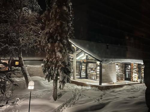 a small house covered in snow at night at Villa Lake Ruka in Ruka