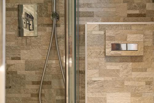 a shower with a glass door in a bathroom at Chalet Edera Myholidaylivigno in Livigno