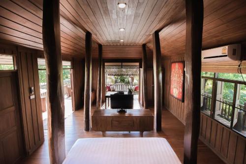 a hallway of a house with wooden walls and wooden floors at Cyngam Retreat- A private pool villa with service in Ban Pa Sao