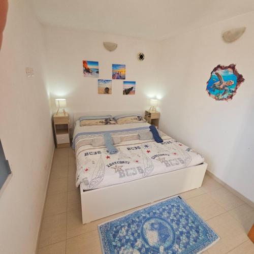 a bedroom with a bed and two night stands at Terrazza a Nettuno in Nettuno