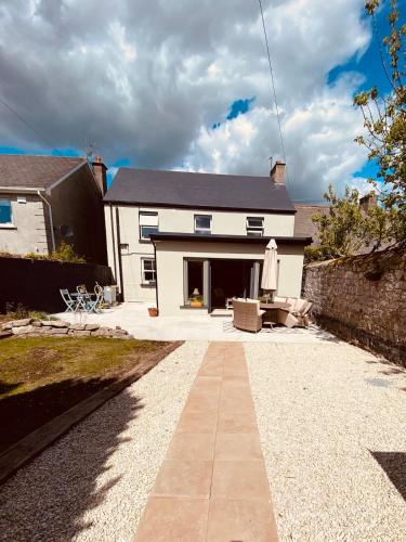 a house with a stone walkway in front of it at Cashel town house 4 bed in Cashel