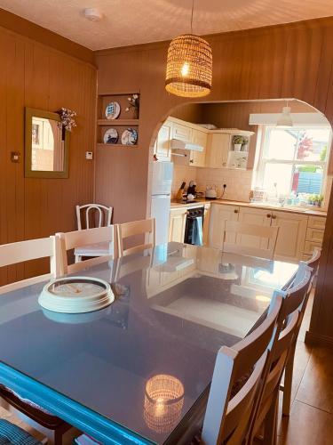 a kitchen with a table with chairs and a dining room at Cashel town house 4 bed in Cashel
