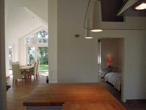a room with a table and a bed and a dining room at Rosenuferhaus in Hestoft